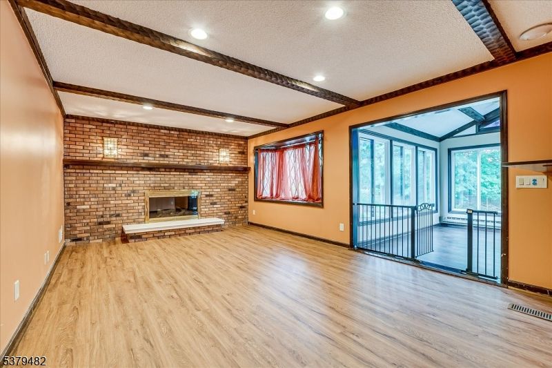 Empty room, Fireplace, Interior, Recessed Lighting, Stone Walls, Wood Texture Flooring