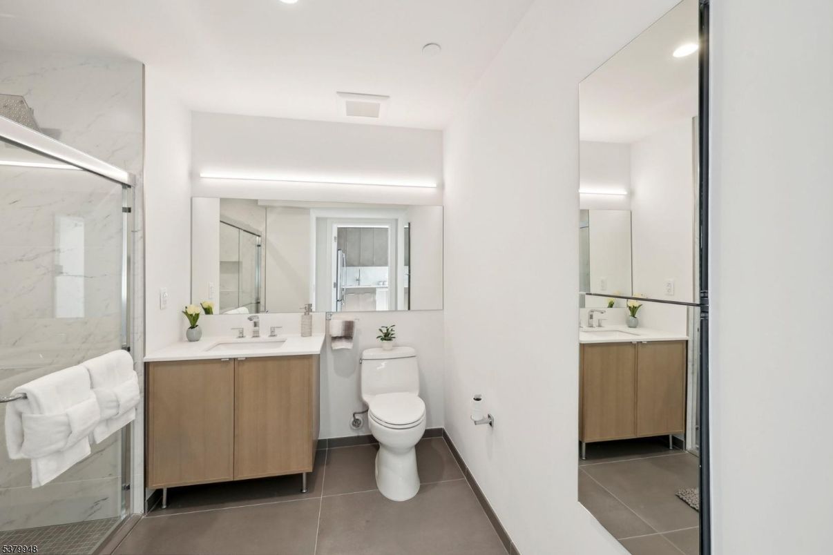 Bathroom, Dual Sink Vanities, Glass Shower, Interior, Marble Walls, Recessed Lighting