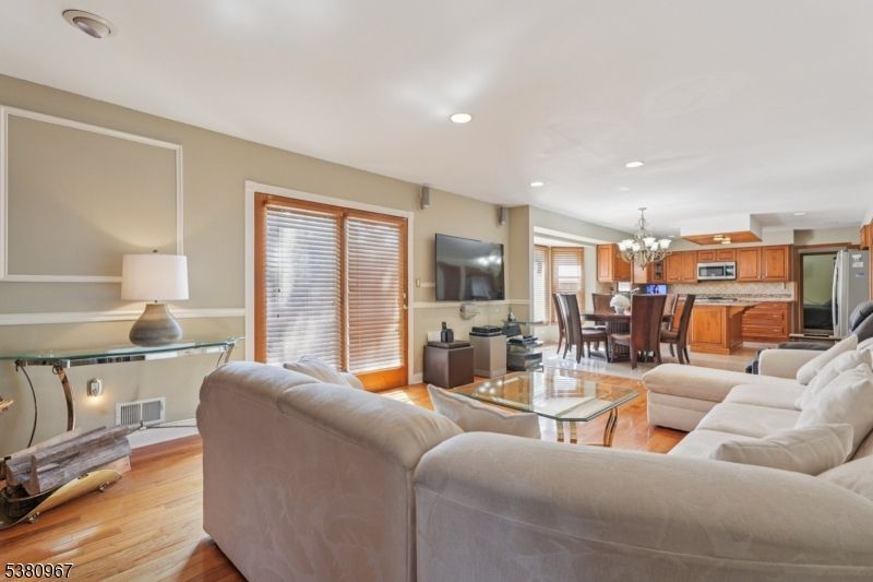 Chandelier, Dining room, Interior, Kitchen, Living room, Recessed Lighting, Stainless Steel Appliances, Wood Texture Flooring