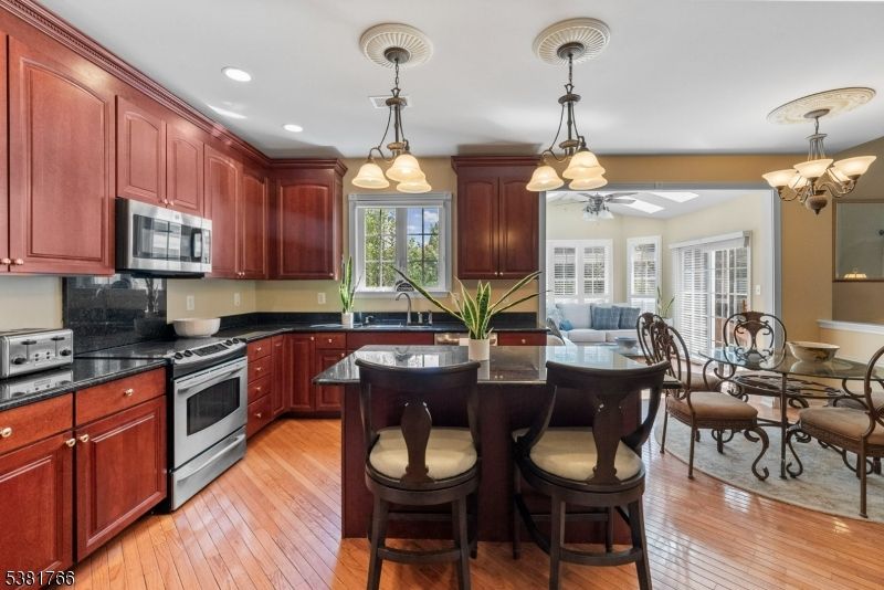 Chandelier, Dining room, Interior, Kitchen, Pendant Lights, Recessed Lighting, Stainless Steel Appliances, Wood Texture Flooring