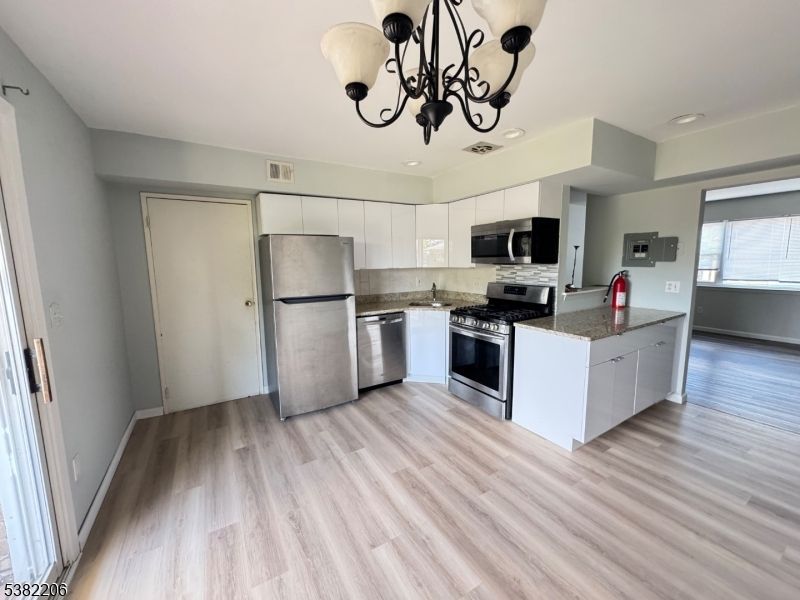 Chandelier, Interior, Kitchen, Recessed Lighting, Stainless Steel Appliances, Wood Texture Flooring