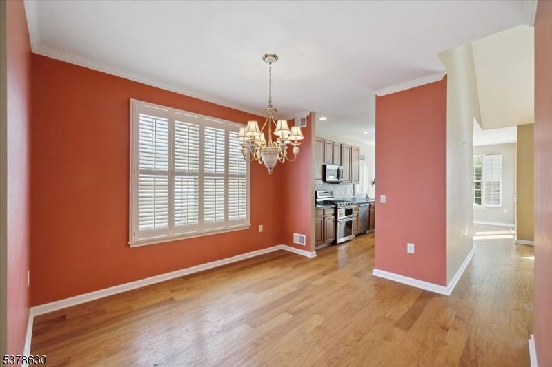 Chandelier, Empty room, Interior, Kitchen, Recessed Lighting, Stainless Steel Appliances, Wood Texture Flooring