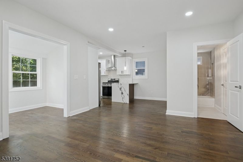 Empty room, Interior, Kitchen, Pendant Lights, Recessed Lighting, Stainless Steel Appliances, Wood Texture Flooring
