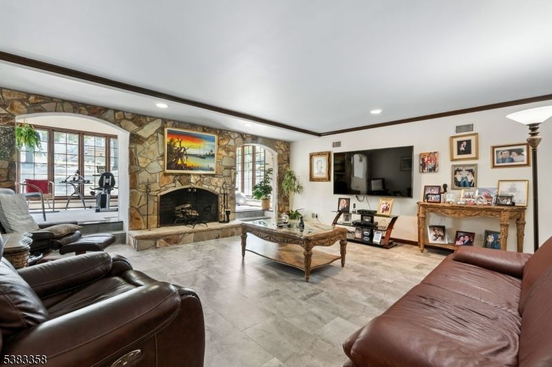 Fireplace, Fitness Equipment, Interior, Living room, Recessed Lighting, Stone Walls