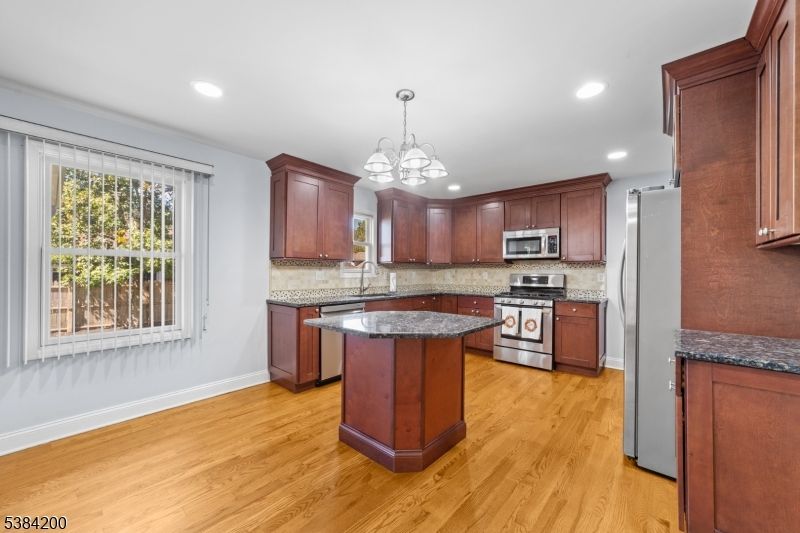 Chandelier, Interior, Kitchen, Pendant Lights, Recessed Lighting, Stainless Steel Appliances, Wood Texture Flooring