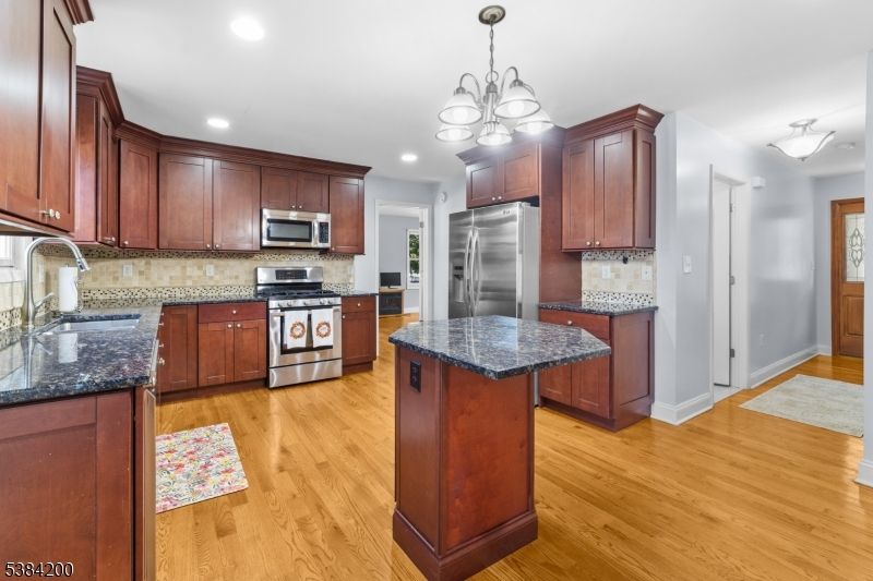 Chandelier, Interior, Kitchen, Recessed Lighting, Stainless Steel Appliances, Wood Texture Flooring