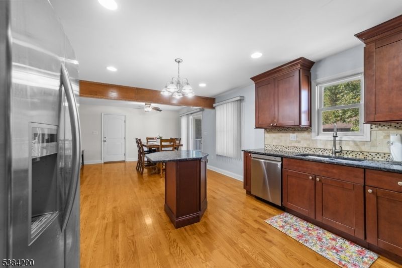 Chandelier, Dining room, Interior, Kitchen, Pendant Lights, Recessed Lighting, Stainless Steel Appliances, Wood Texture Flooring