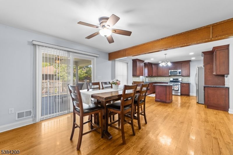 Chandelier, Dining room, Interior, Kitchen, Recessed Lighting, Stainless Steel Appliances, Wooden Beams, Wood Texture Flooring
