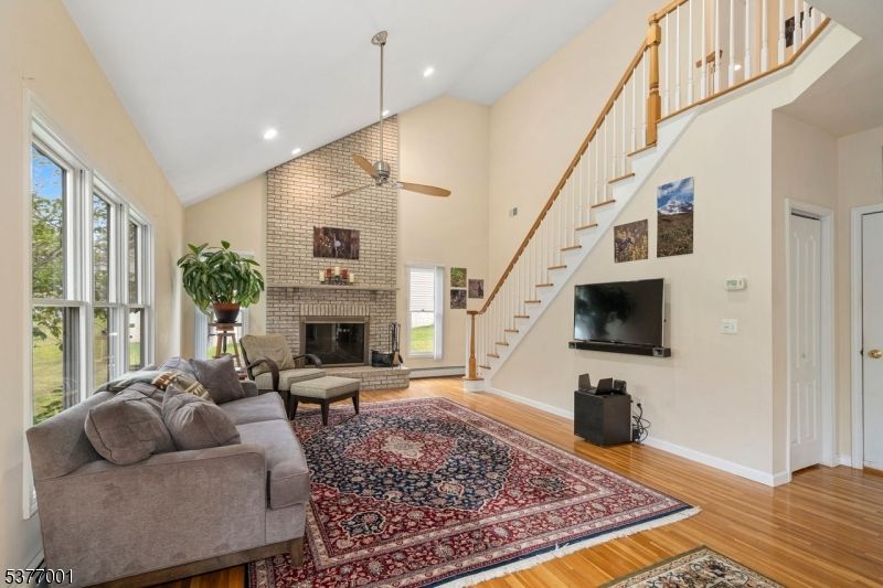 Fireplace, Interior, Living room, Recessed Lighting, Stone Walls, Wood Texture Flooring