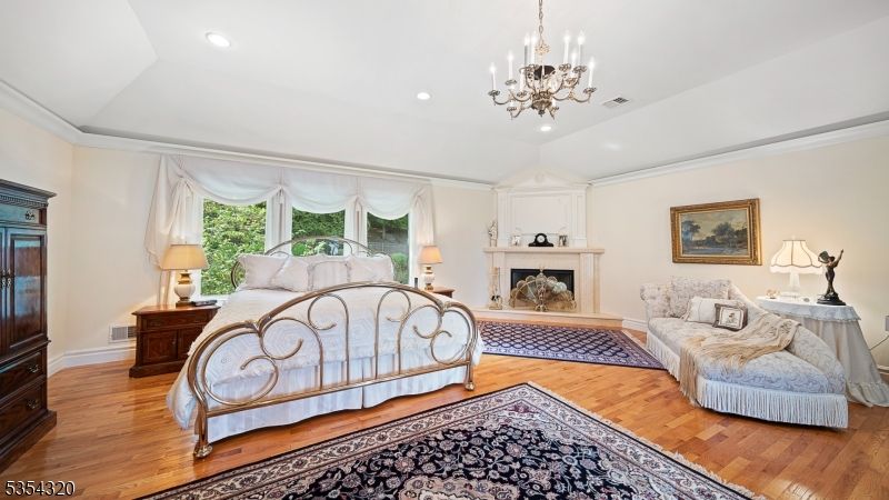 Bedroom, Chandelier, Fireplace, Interior, Recessed Lighting, Wood Texture Flooring