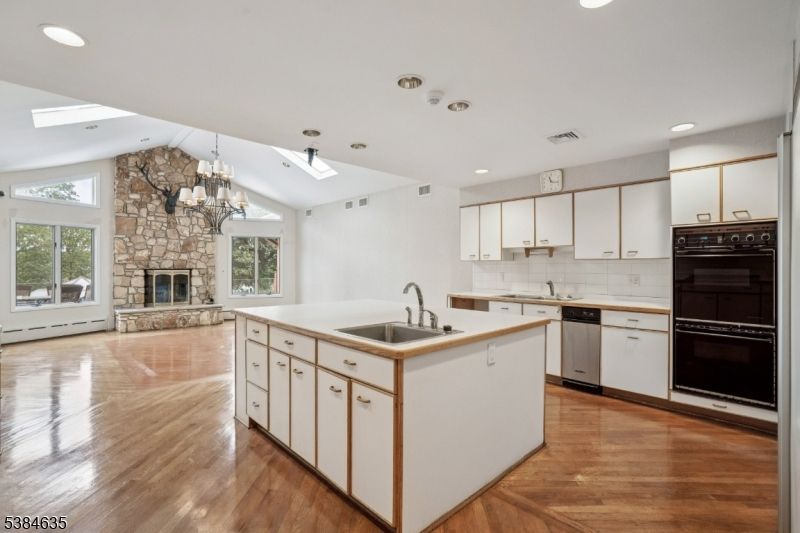 Chandelier, Fireplace, Interior, Kitchen, Recessed Lighting, Stone Walls, Wood Texture Flooring