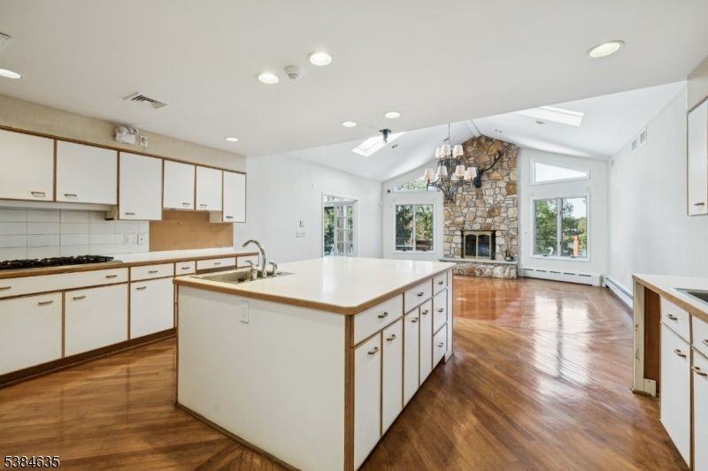 Chandelier, Empty room, Fireplace, Interior, Kitchen, Pendant Lights, Recessed Lighting, Stone Walls, Wood Texture Flooring