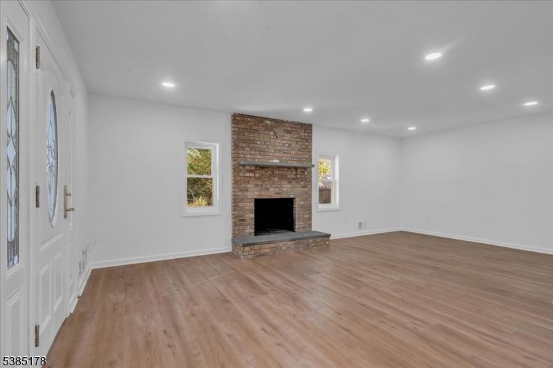 Empty room, Fireplace, Interior, Recessed Lighting, Stone Walls, Wood Texture Flooring