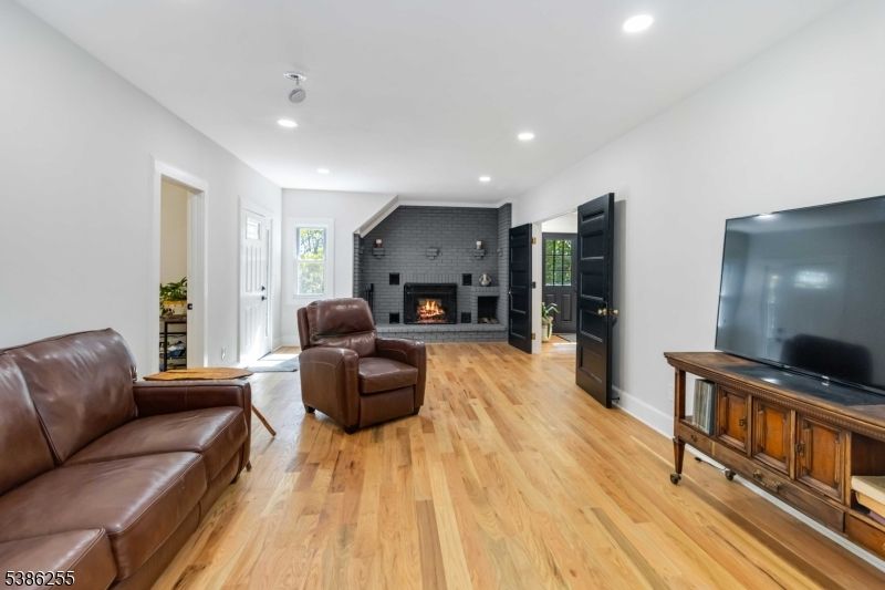 Fireplace, Interior, Living room, Recessed Lighting, Stone Walls, Wood Texture Flooring