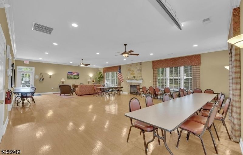 Dining room, Fireplace, Interior, Recessed Lighting, Stone Walls, Wood Texture Flooring