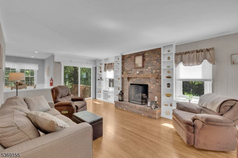 Fireplace, Interior, Living room, Recessed Lighting, Stone Walls, Wood Texture Flooring