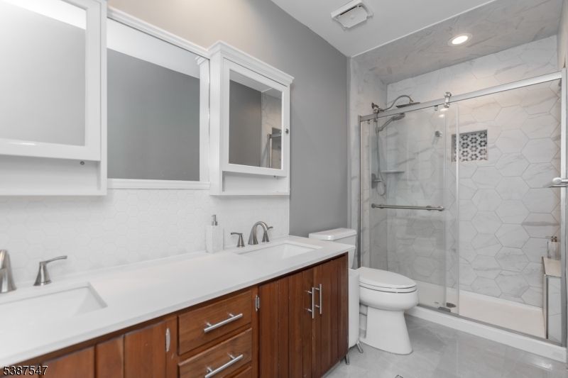 Bathroom, Dual Sink Vanities, Glass Shower, Interior, Marble Walls, Recessed Lighting
