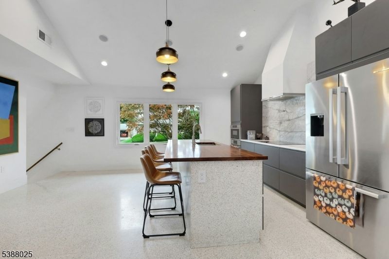 Interior, Kitchen, Marble Walls, Pendant Lights, Recessed Lighting, Stainless Steel Appliances