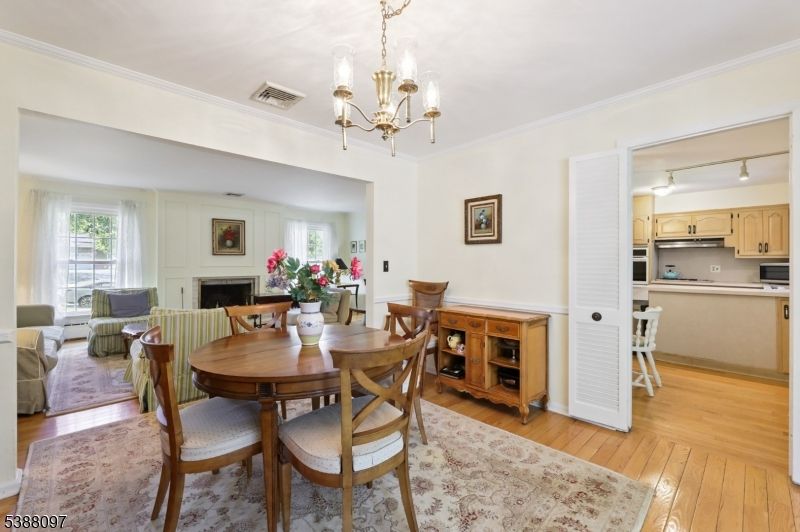 Chandelier, Dining room, Fireplace, Interior, Kitchen, Living room, Stainless Steel Appliances, Wood Texture Flooring