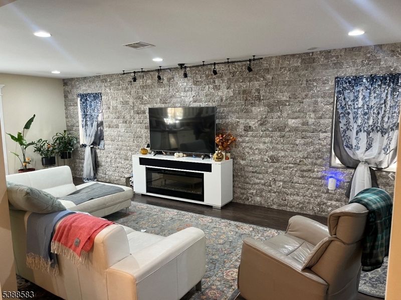 Fireplace, Interior, Living room, Recessed Lighting, Stone Walls, Wood Texture Flooring