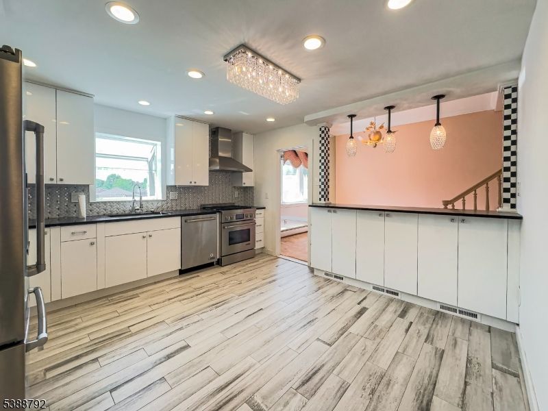 Chandelier, Interior, Kitchen, Pendant Lights, Recessed Lighting, Stainless Steel Appliances, Wood Texture Flooring