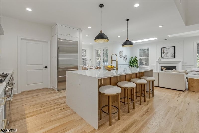 Fireplace, Interior, Kitchen, Living room, Pendant Lights, Recessed Lighting, Stainless Steel Appliances, Wood Texture Flooring