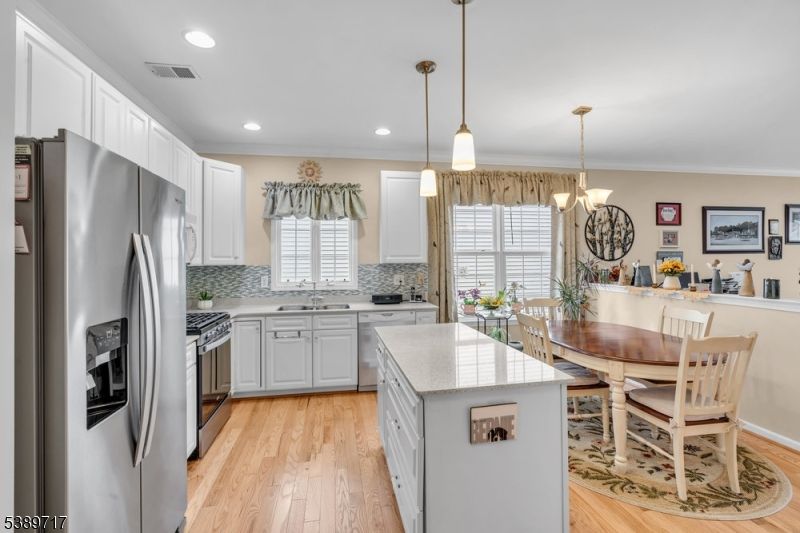 Chandelier, Dining room, Interior, Kitchen, Pendant Lights, Recessed Lighting, Stainless Steel Appliances, Wood Texture Flooring