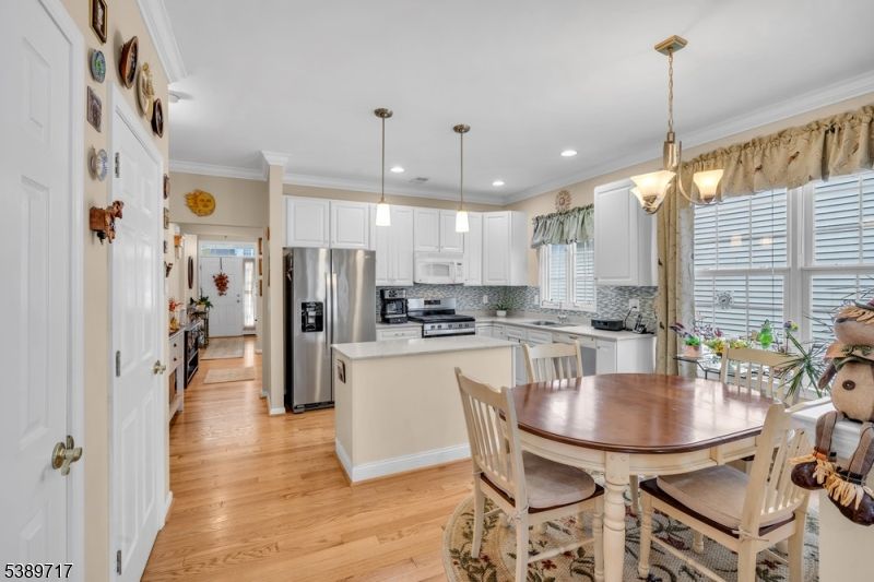 Dining room, Interior, Kitchen, Pendant Lights, Recessed Lighting, Stainless Steel Appliances, Wood Texture Flooring