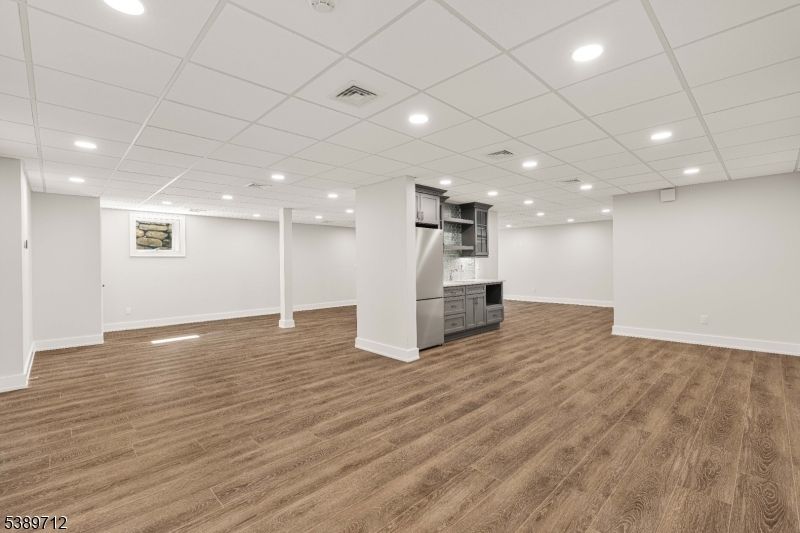 Empty room, Interior, Kitchen, Recessed Lighting, Stainless Steel Appliances, Wood Texture Flooring