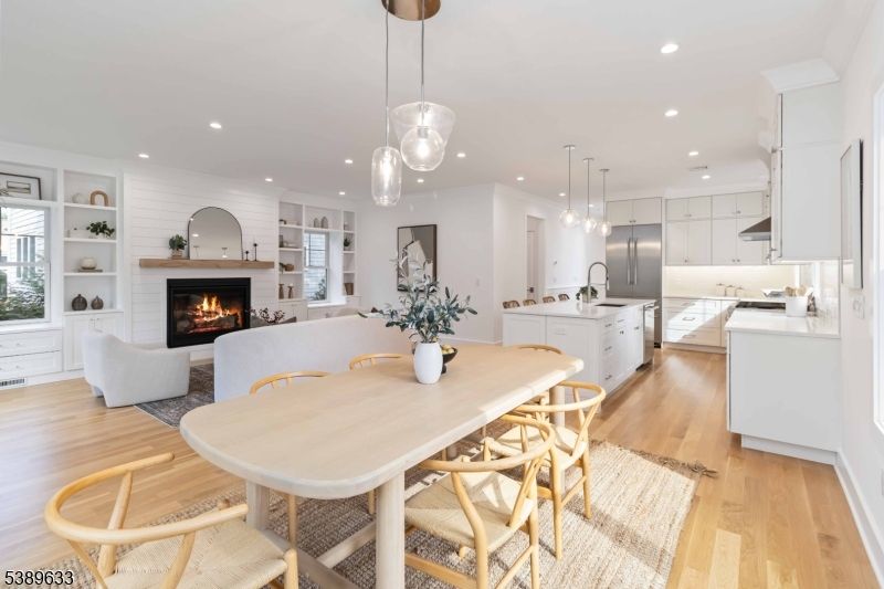 Dining room, Fireplace, Interior, Kitchen, Living room, Pendant Lights, Recessed Lighting, Stainless Steel Appliances, Wood Texture Flooring