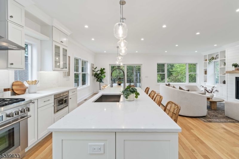 Fireplace, Interior, Kitchen, Living room, Pendant Lights, Recessed Lighting, Stainless Steel Appliances, Wood Texture Flooring