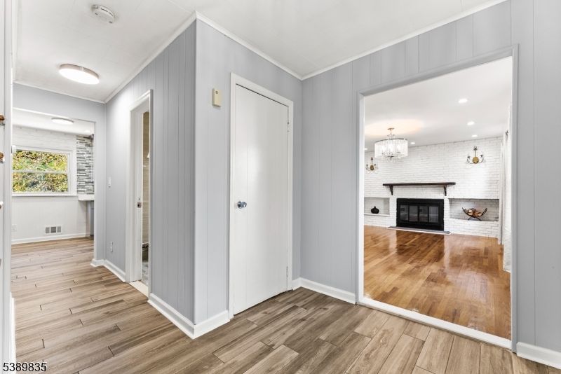 Chandelier, Empty room, Fireplace, Interior, Recessed Lighting, Wood Texture Flooring