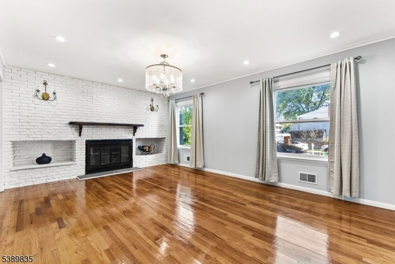 Chandelier, Empty room, Fireplace, Interior, Recessed Lighting, Stone Walls, Wood Texture Flooring