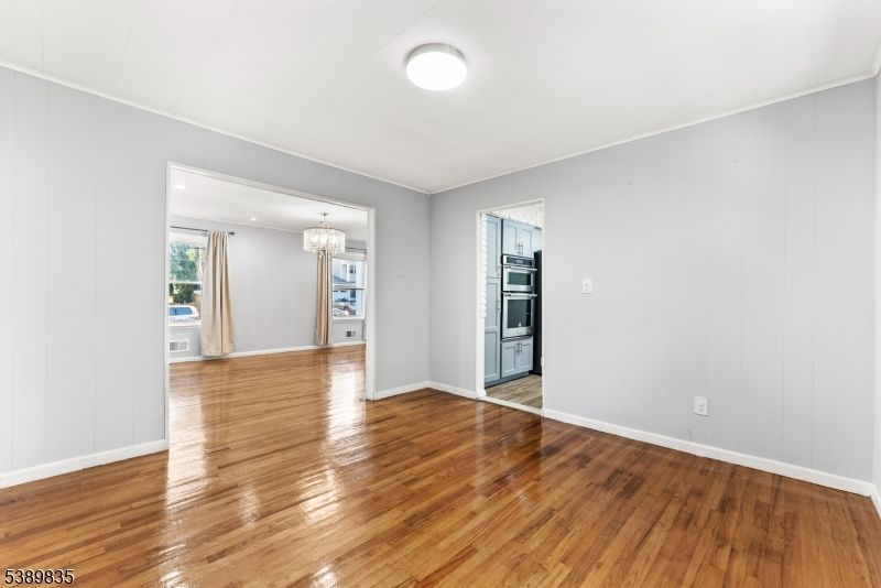 Chandelier, Empty room, Interior, Kitchen, Recessed Lighting, Stainless Steel Appliances, Wood Texture Flooring