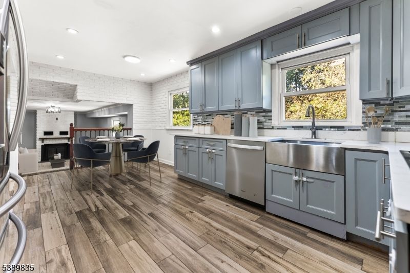 Dining room, Fireplace, Interior, Kitchen, Recessed Lighting, Stainless Steel Appliances, Wood Texture Flooring