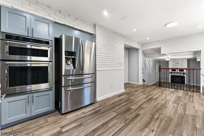 Dining room, Interior, Kitchen, Recessed Lighting, Stainless Steel Appliances, Stone Walls, Wood Texture Flooring