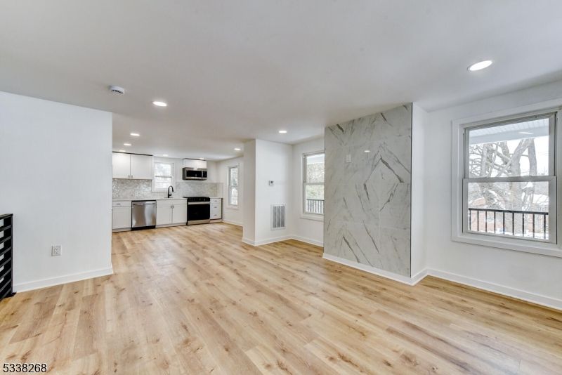 Empty room, Interior, Kitchen, Marble Walls, Recessed Lighting, Stainless Steel Appliances, Wood Texture Flooring