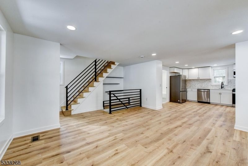 Empty room, Interior, Kitchen, Recessed Lighting, Stainless Steel Appliances, Wood Texture Flooring