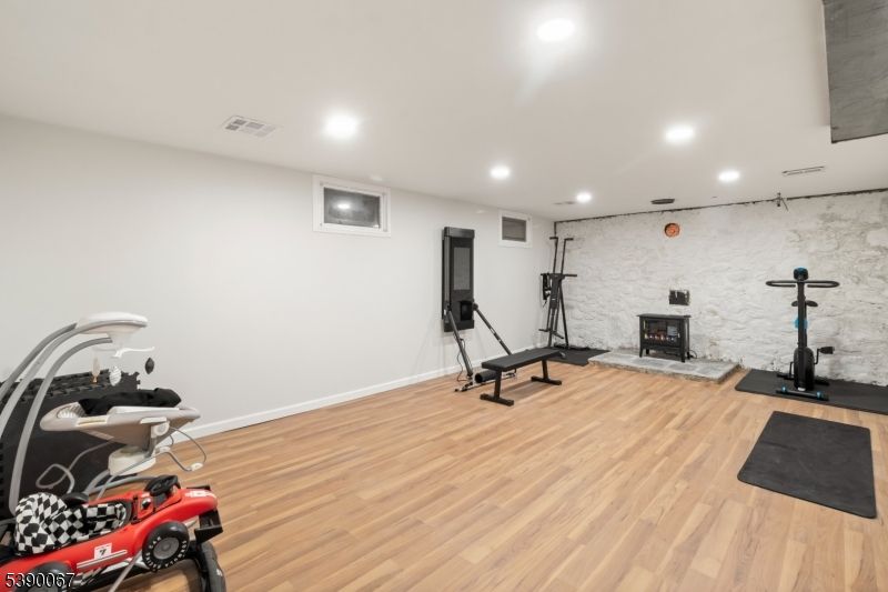 Fireplace, Fitness Equipment, Interior, Recessed Lighting, Wood Texture Flooring