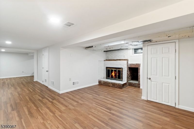 Empty room, Fireplace, Interior, Recessed Lighting, Stone Walls, Wood Texture Flooring