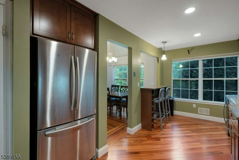 Chandelier, Dining room, Interior, Kitchen, Pendant Lights, Recessed Lighting, Stainless Steel Appliances, Wood Texture Flooring
