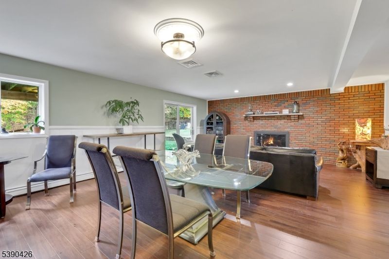 Dining room, Fireplace, Interior, Living room, Recessed Lighting, Stone Walls, Wood Texture Flooring