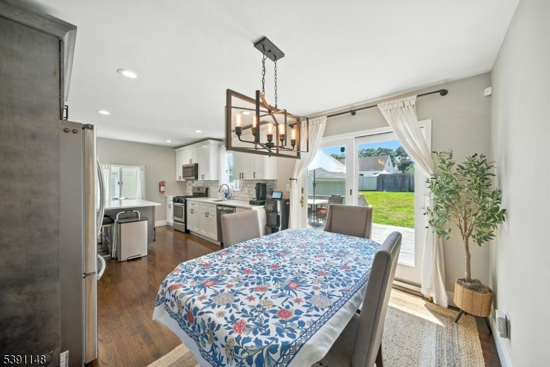 Chandelier, Dining room, Interior, Kitchen, Pendant Lights, Recessed Lighting, Stainless Steel Appliances, Wood Texture Flooring