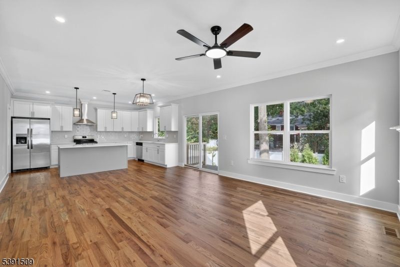 Chandelier, Empty room, Interior, Kitchen, Pendant Lights, Recessed Lighting, Stainless Steel Appliances, Wood Texture Flooring