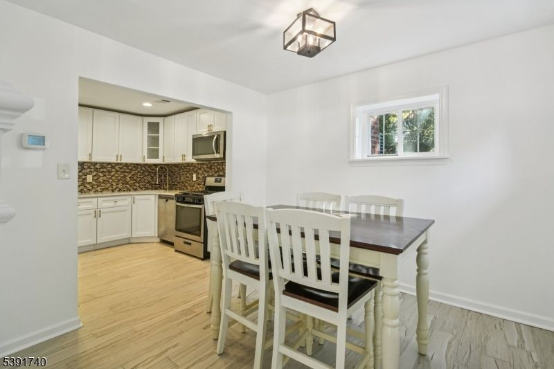 Dining room, Interior, Kitchen, Recessed Lighting, Stainless Steel Appliances, Wood Texture Flooring