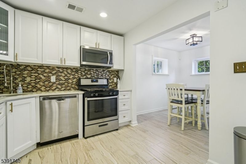 Dining room, Interior, Kitchen, Recessed Lighting, Stainless Steel Appliances, Wood Texture Flooring