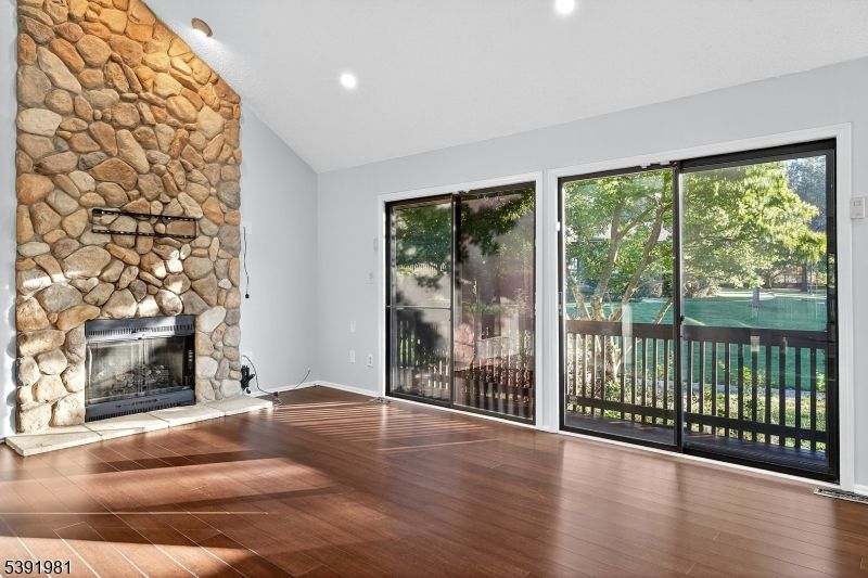 Empty room, Fireplace, Interior, Recessed Lighting, Stone Walls, Wood Texture Flooring