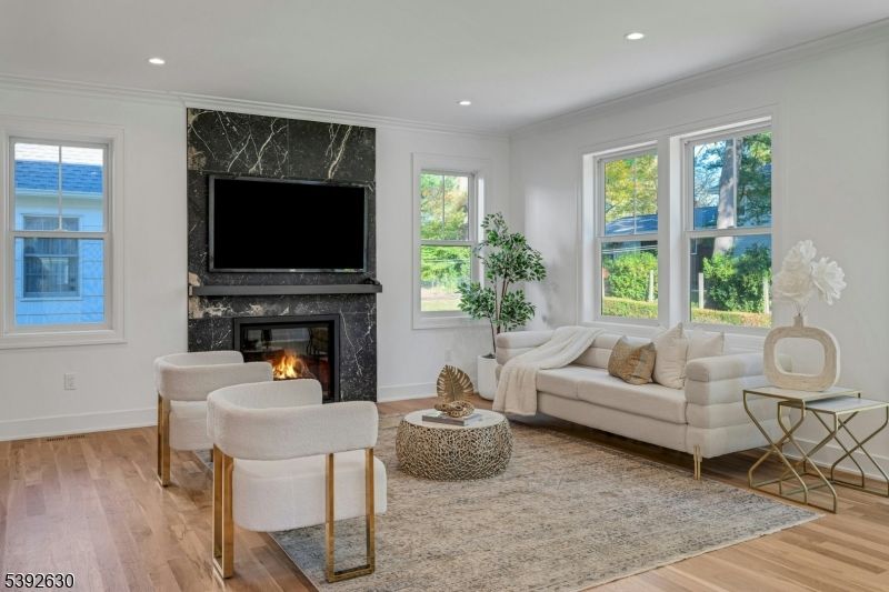 Fireplace, Interior, Living room, Marble Walls, Recessed Lighting, Wood Texture Flooring