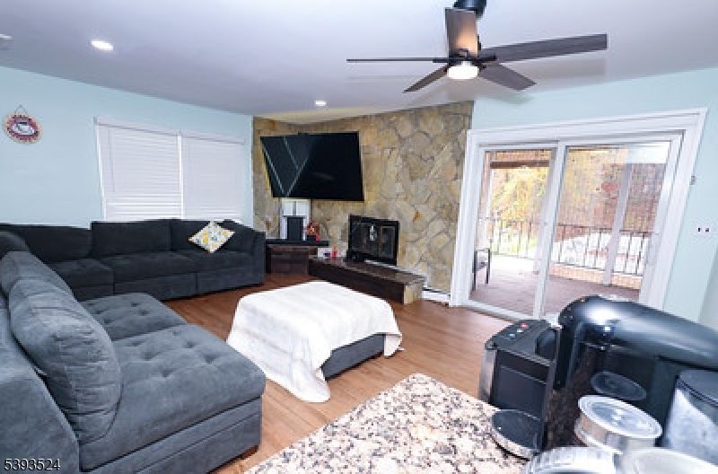 Fireplace, Interior, Living room, Recessed Lighting, Stone Walls, Wood Texture Flooring