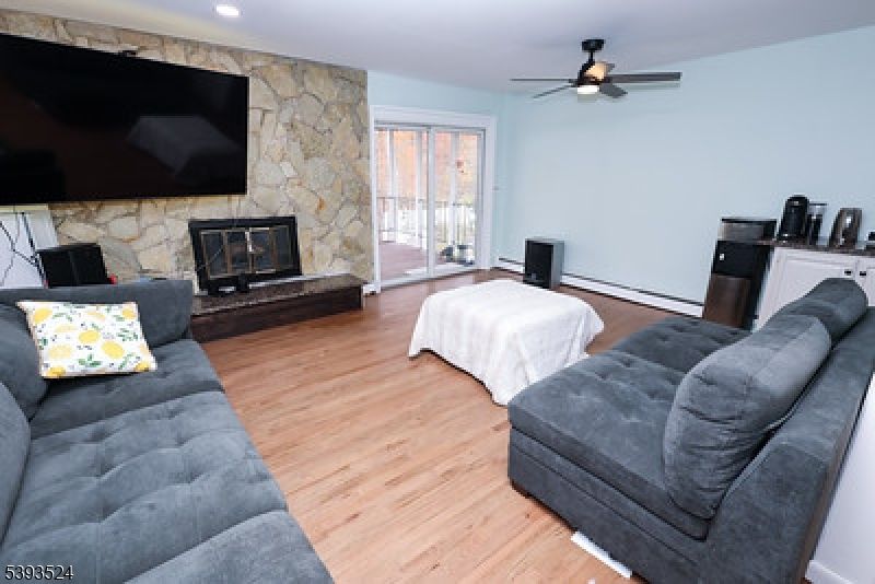 Fireplace, Interior, Living room, Recessed Lighting, Stone Walls, Wood Texture Flooring